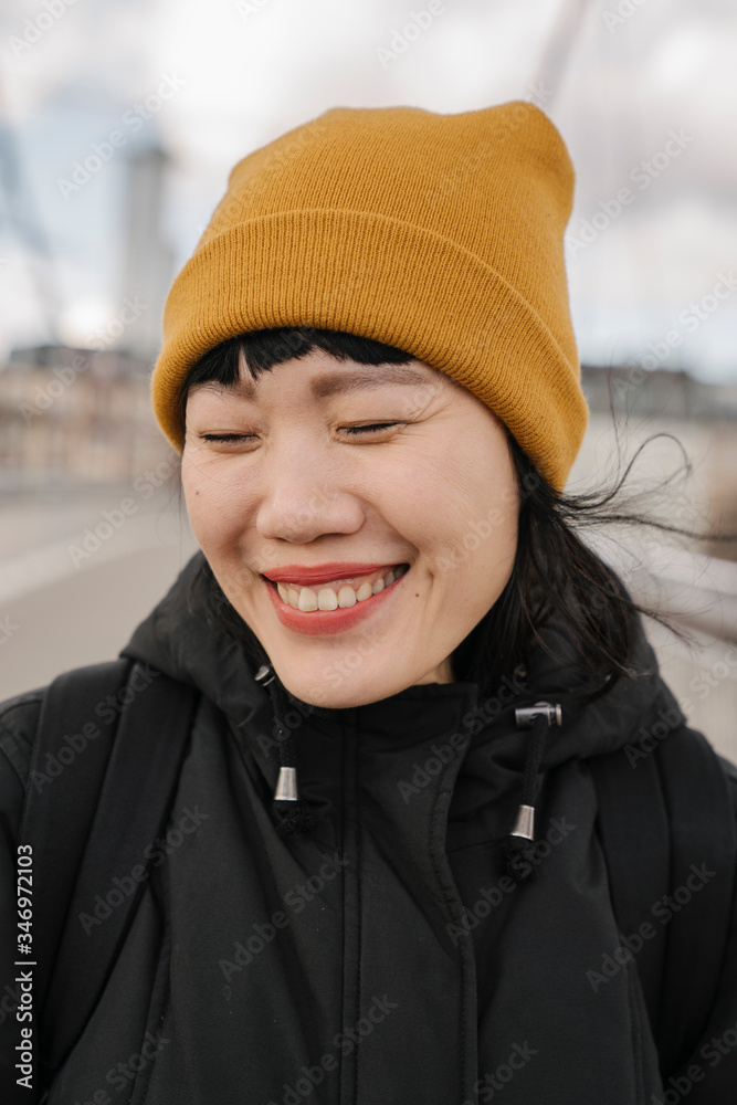 Portrait of happy woman with closed eyes on a bridge Portrait of happy woman with closed eyes on a bridge