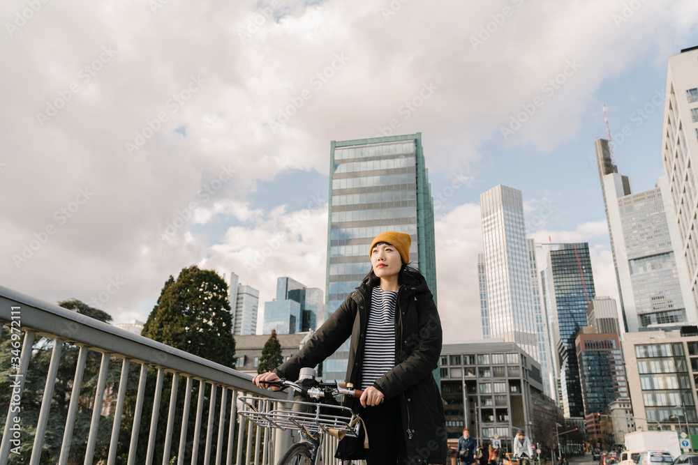 Woman with bicycle in the city, Frankfurt, Germany Woman with bicycle in the city, Frankfurt, Germany