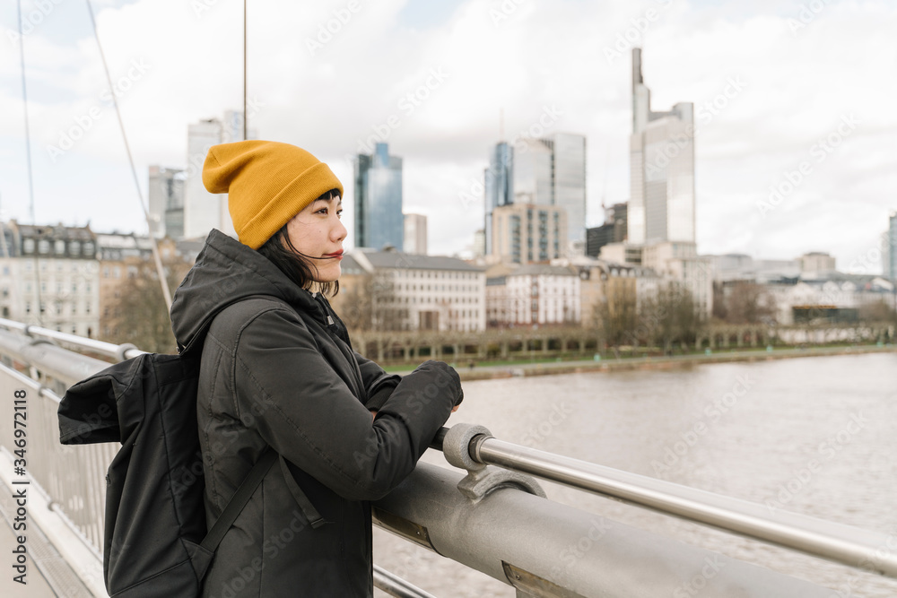 Woman on a bridge enjoying the view, Frankfurt, Germany Woman on a bridge enjoying the view, Frankfurt, Germany