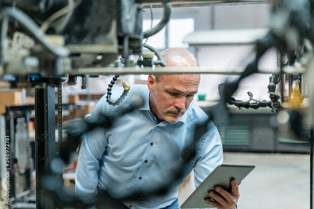 Businessman using tablet in a factory Businessman using tablet in a factory