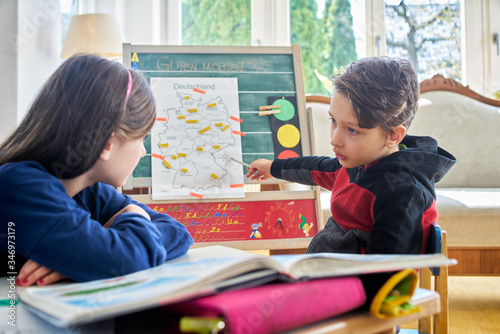 Brother and sister learing at home during school closure