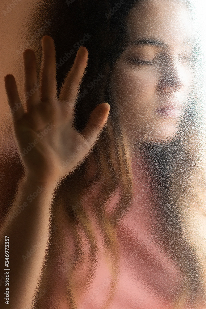 Portrait of teenage girl with eyes closed behind glass pane Portrait of teenage girl with eyes closed behind glass pane