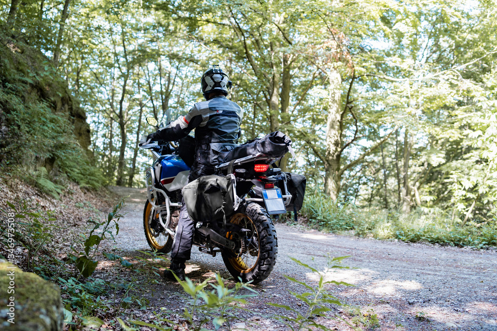 Motorcyclist on a trip on a forest road