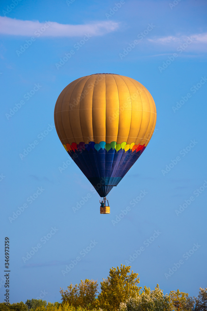 Fototapeta premium Colorful hot air balloon flying in blue sky