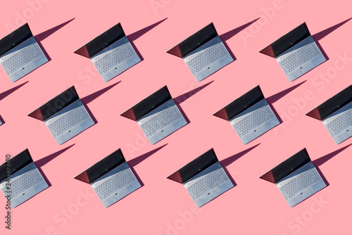 Laptops on pink background
