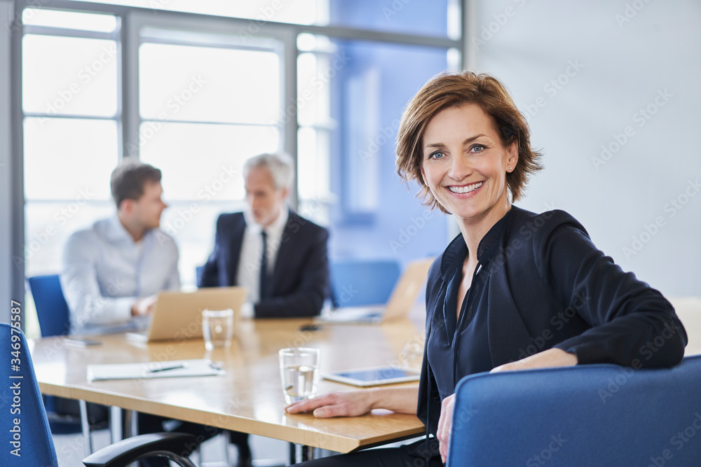 Portrait of smiling businesswoman during a meeting in office Portrait of smiling businesswoman during a meeting in office