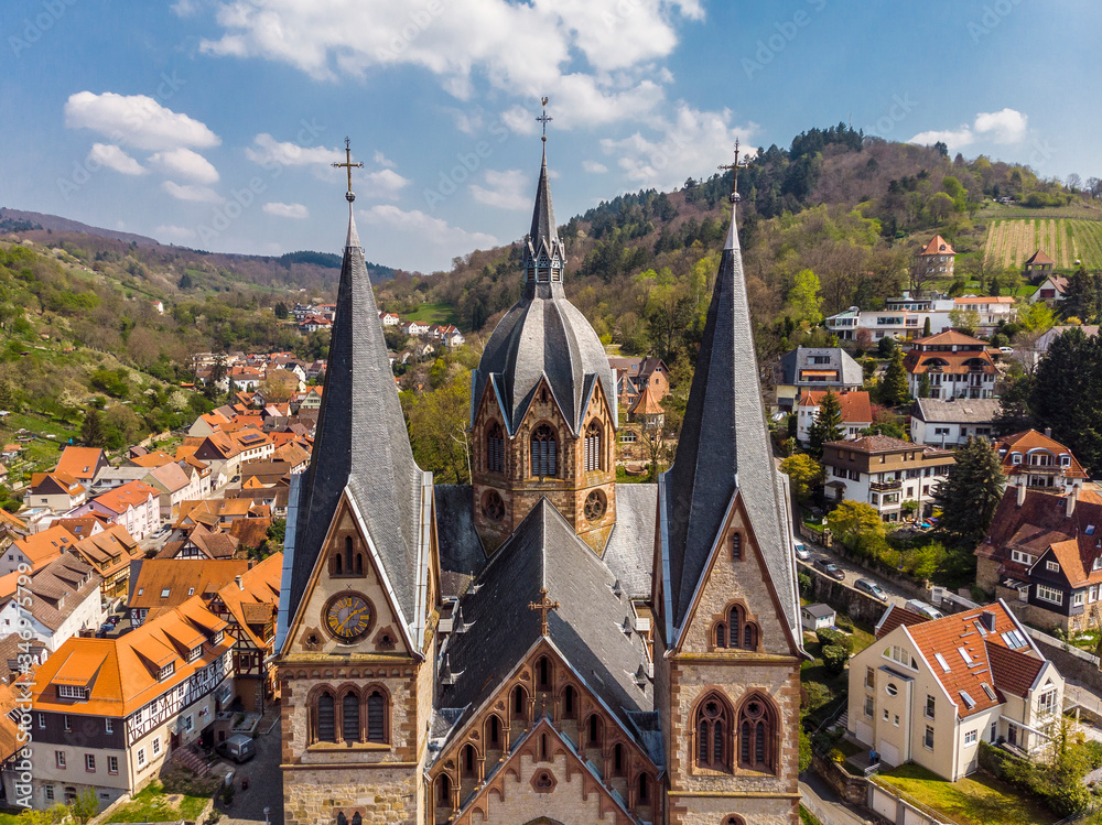 Beautiful spring photo from above on a church in Heppenheim Orange house roofs, mountains and a blue sky in the background. Germany.