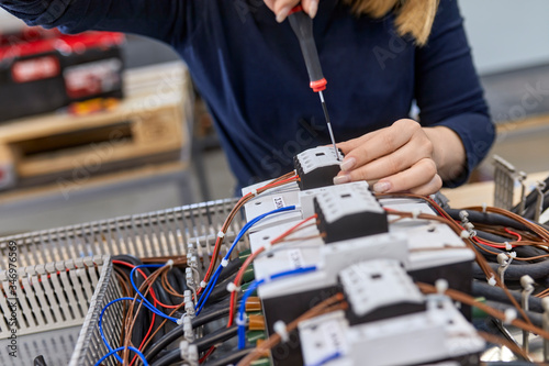 Close-up of electrician working on circuitry in workshop photo