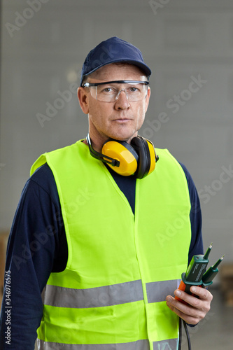 Portrait of worker in protective workwear photo
