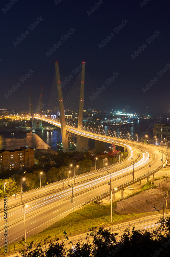 Golden bridge in Vladivostok at night. Night traffic. Golden Bridge in sunset, Vladivostok, Russia.