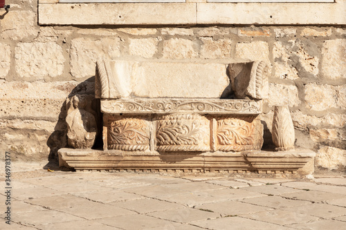 A bench in Korcula on the main square in front of St. Marks Cathedral. This bench is made of limestone composed out of different old elements © Lea