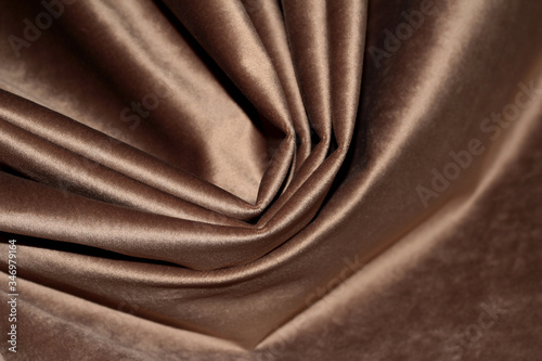 Velour background with drapery. Velour color of coffee with milk. Velour background with pleats.