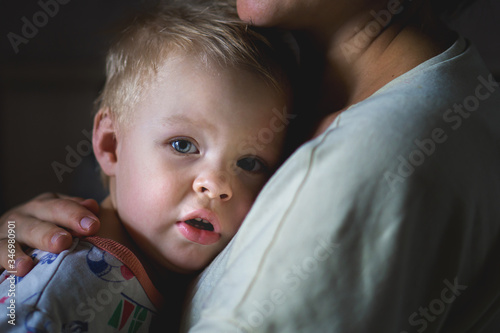 A tearful little boy clings to his mother to calm down. A mother's care and custody. The relationship between parents and children