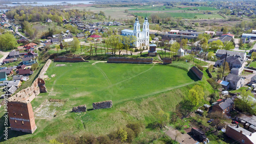 Aerial View of the Ludza Medieval Castle Ruins on a Hill Between Big Ludza Lake and Small Ludza Lake and the Roman Catholic Church in Background photo