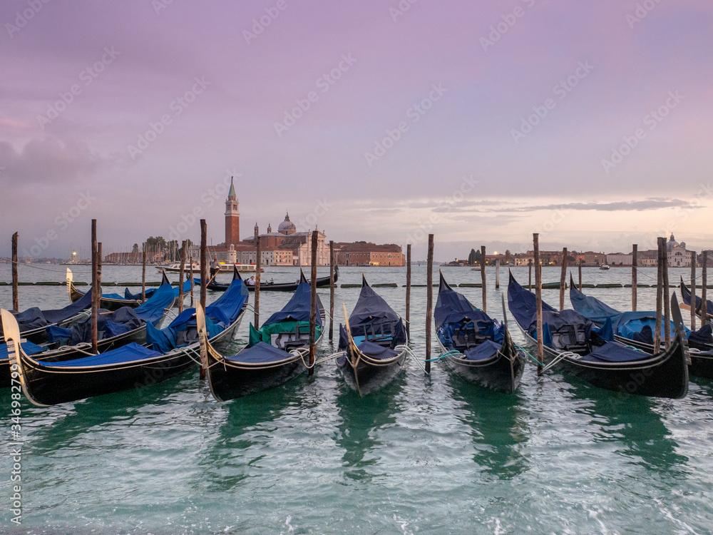 Beautiful sunset from San Marco square, Venice, Italy, and the gondolas in the foreground and the church of San Giorgio Maggiore