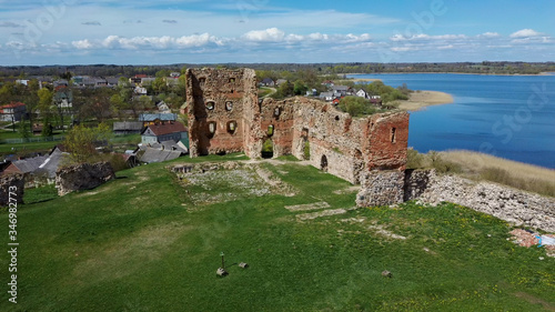 Aerial View of the Ludza Medieval Castle Ruins on a Hill Between Big Ludza Lake and Small Ludza Lake. The Ruins of an Ancient Castle in Latvia. photo