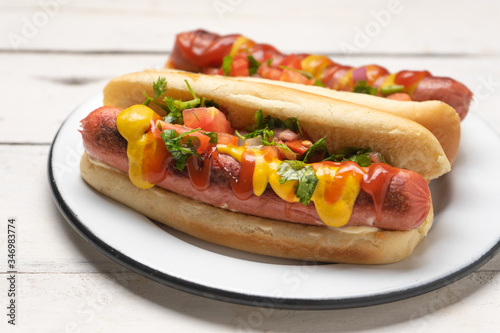 Hot dog with pico de gallo salad on white background