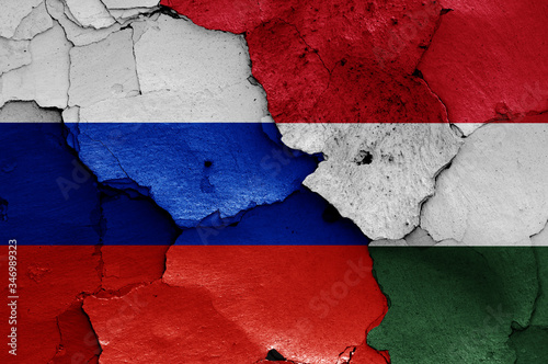 flags of Russia and Hungary painted on cracked wall