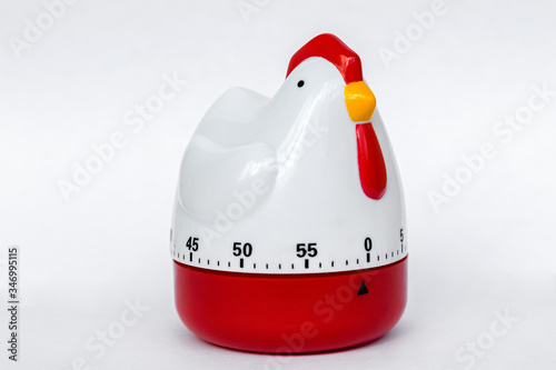 Kitchen timer in the form of chicken made of plastic on a white background. Clock for cooking. With a timeline. Isolated.

