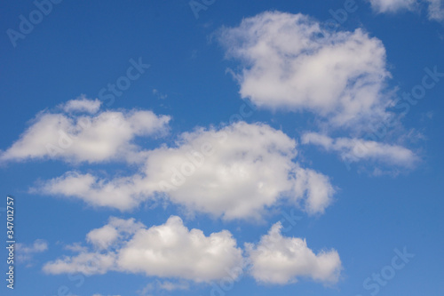 Bright blue sky with white clouds. Sunny day