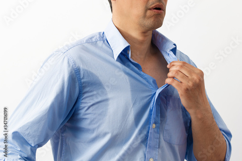 Shot of an unrecognizable man dressing himself with white background