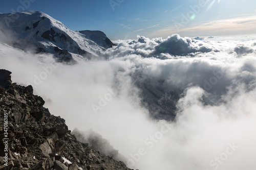 Clouds and fog over the Chamonix valley. View from the Cosmique refuge, Chamonix, France. Perfect moment in alpine highlands. © almostfuture