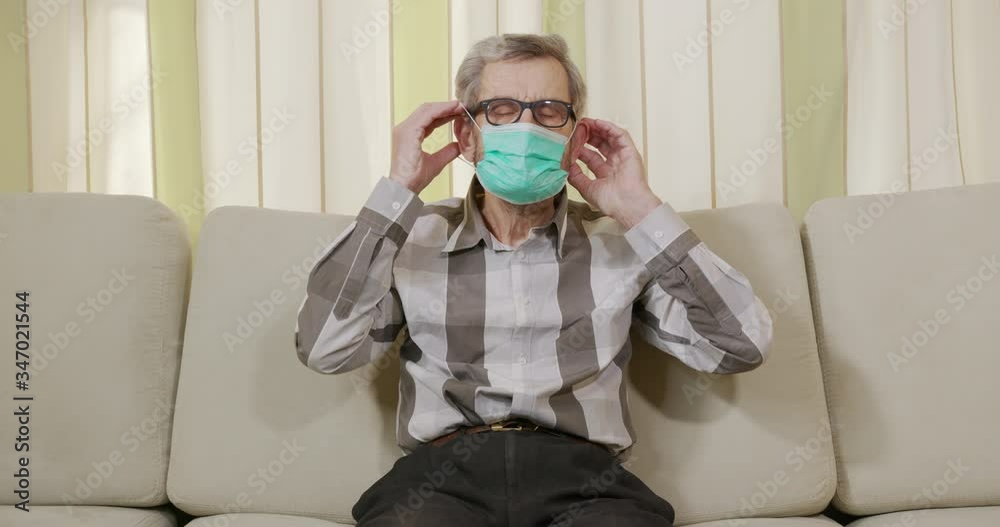 Portrait Of Elderly Man In Medical Mask On Their Face To Protect Virus. Portrait Of Elderly Man In Medical Mask On Their Face To Protect Virus.