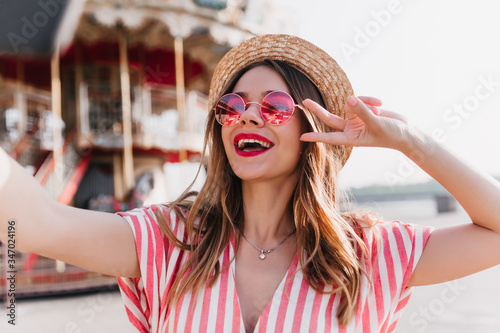 Vászonkép Happy european girl chilling in amusement park in her vacation