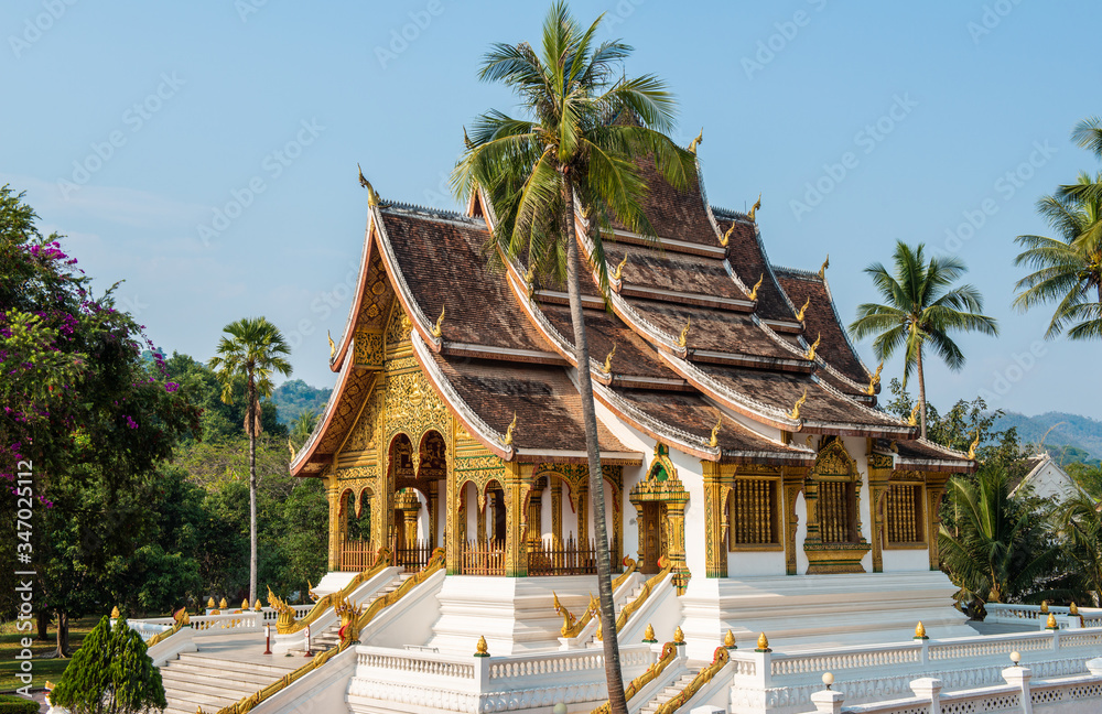 Fototapeta premium An iconic Buddhist temple in the royal palace of Luang Prabang, the UNESCO world heritage site in north central of Laos. The Haw Pha Bang, that was built to enshrine the Phra Bang Buddha statue.