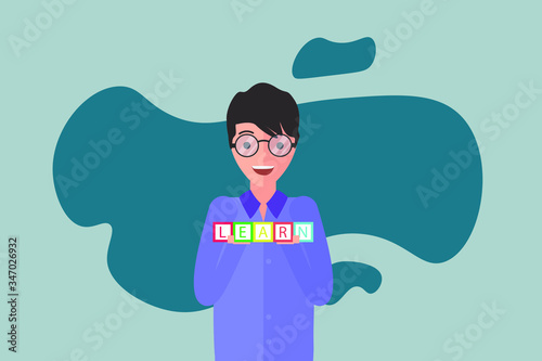 Student holding wooden letter blocks with the word: Learn