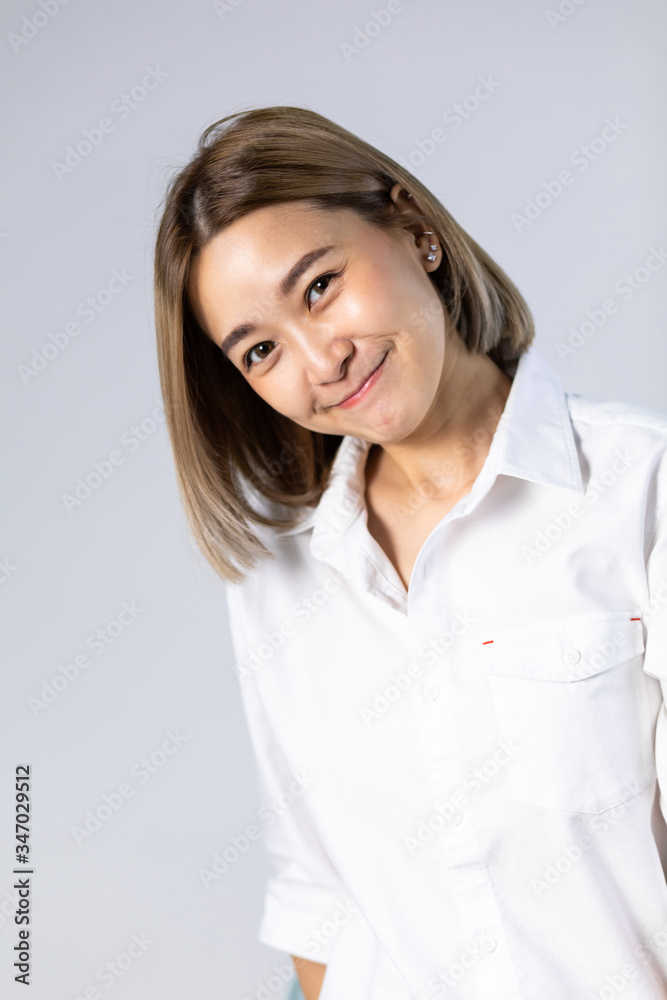 Portrait of Young Asian pretty cute cheerful business woman keeping arms crossed and smiling close up and looking at camera on white background. natural make-up, and white teeth Portrait of Young Asian pretty cute cheerful business woman keeping arms crossed and smiling close up and looking at camera on white background. natural make-up, and white teeth