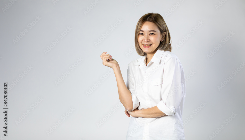 Portrait of Young Asian pretty cute cheerful woman wearing braces and looking at camera on white background. natural make-up, and white teeth Portrait of Young Asian pretty cute cheerful woman wearing braces and looking at camera on white background. natural make-up, and white teeth