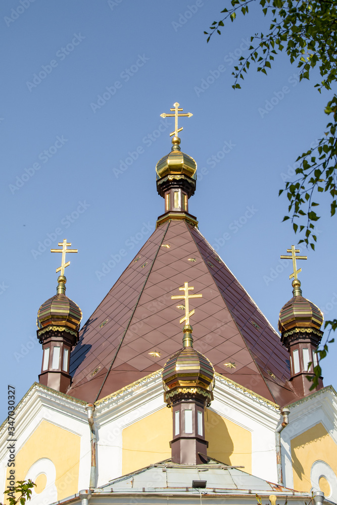 Golden crosses of the Orthodox Church against the sky.
