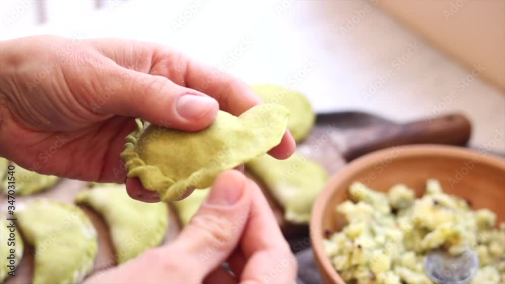 Woman hands sculpt dumplings, potato stuffed. Dough and filling. Make vegan food Woman hands sculpt dumplings, potato stuffed. Dough and filling. Make vegan food
