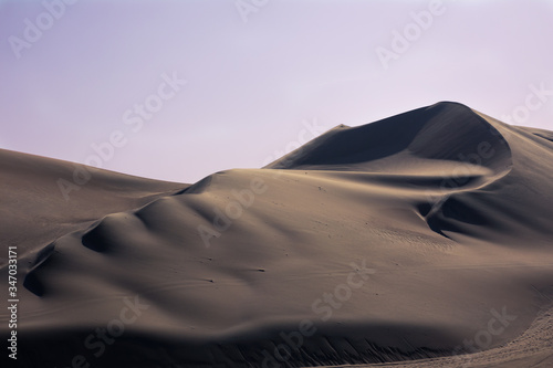Sunset in the desert dunes  in the oasis of Huacachina Peru. One