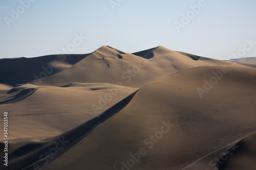 Sunset in the desert dunes, in the oasis of Huacachina Peru. Two