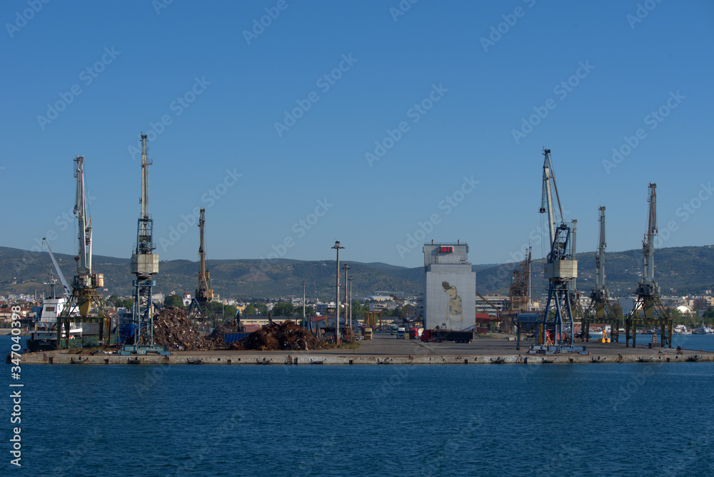 Volos  , Greece , 5/8/2020 . Mobile port cranes are loading scrap metal for recycling