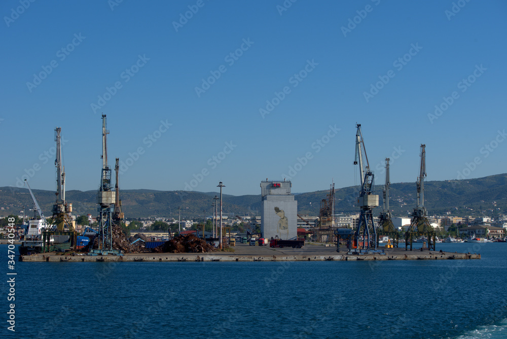 Volos  , Greece , 5/8/2020 . Mobile port cranes are loading scrap metal for recycling