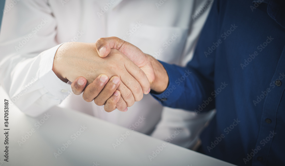 two businessman shake hand after complete success project with teamwork. two businessman shake hand after complete success project with teamwork.