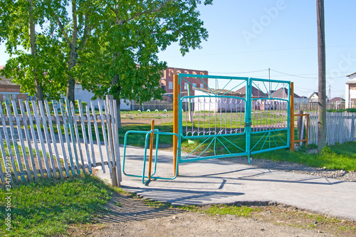 rotating gate in the fence on the sidewalk