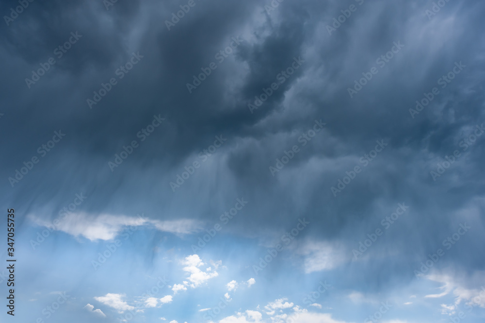 Rain during a thunderstorm and majestic clouds in sky