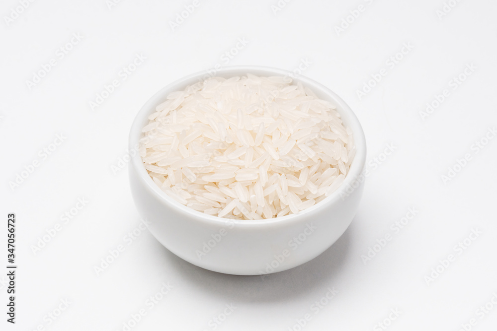 Jasmine rice bowl on white background. Rice comes from seeds of grass, it is the most consumed staple food ingredient. Jasmine rice is a type of fragant long grain rice often used in chinese cuisine. Jasmine rice bowl on white background. Rice comes from seeds of grass, it is the most consumed staple food ingredient. Jasmine rice is a type of fragant long grain rice often used in chinese cuisine.