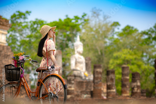 Photography Woman traveller riding retro bicycle enjoy sightseeing takes a picture photo and