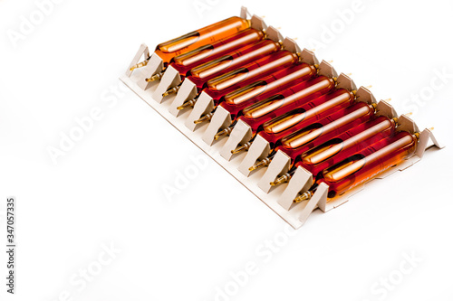 Packing of glass ampoules with a medical preparation shot on a white background.