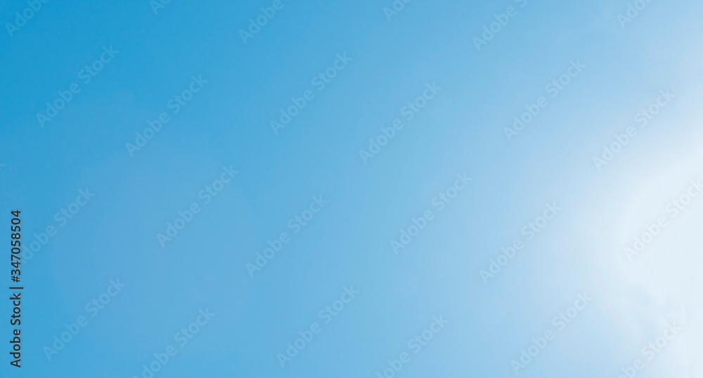 The brilliance of a sparkling blue sky lit by the sun in a spring day as a decorative background