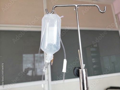Close up saline IV drip Infusion bottle with IV solution for patient in ward hospital
