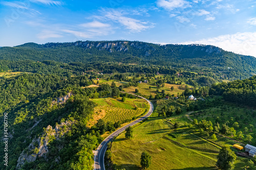 Small mountain houses on the plateau on the mountain in Montenegro on the sunny summer morning.