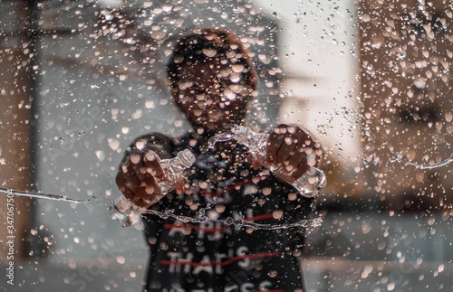 young man playing with water bottles.