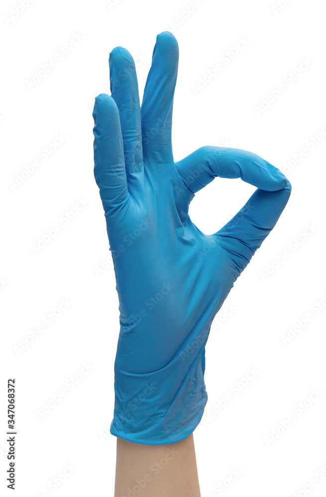 Hand in blue medical gloves showing ok sign. Isolated on white. Hand in blue medical gloves showing ok sign. Isolated on white.