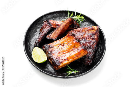 Grilled and smoked pork ribs with barbeque sauce and rosemary isolated on white background